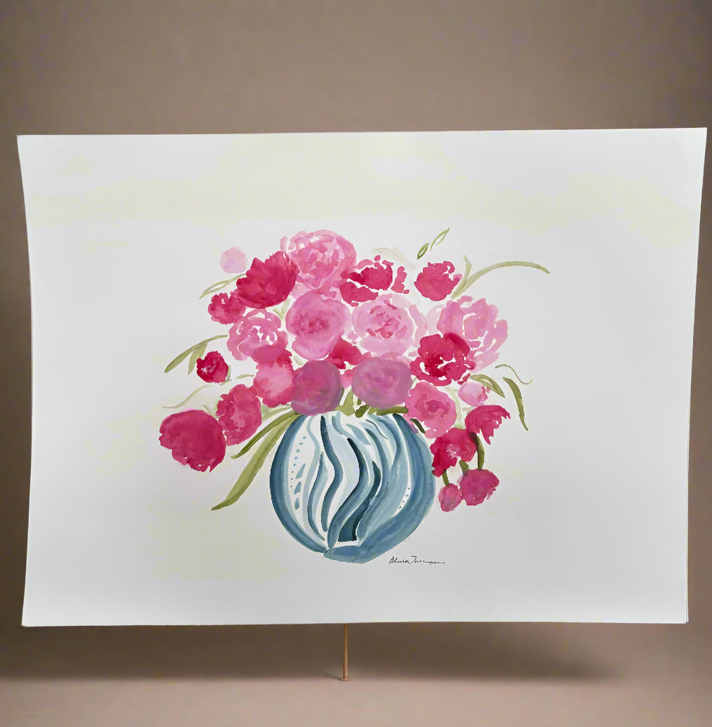 Floral design on a white paper held against a neutral background
